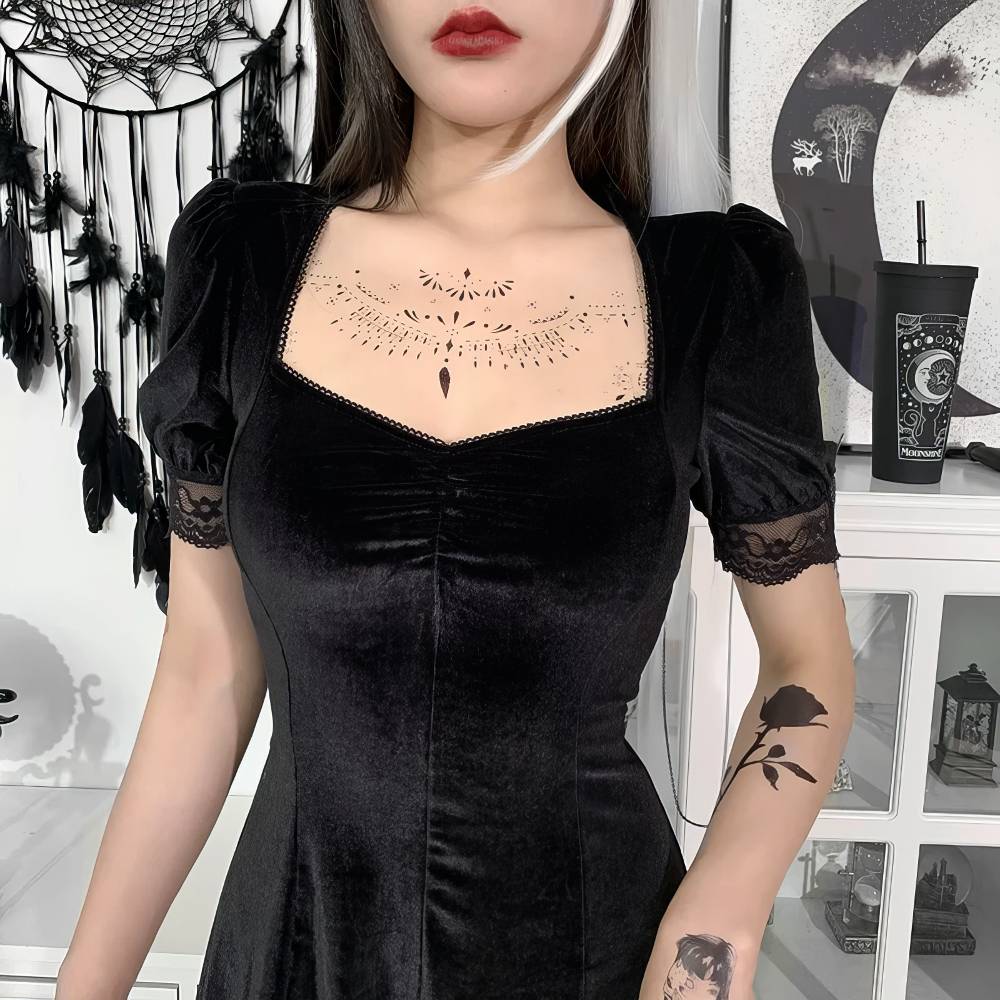 Robe gothique chic noire en velours avec manches courtes bouffantes et dentelle noire sur les bords, vue rapprochée sur le buste