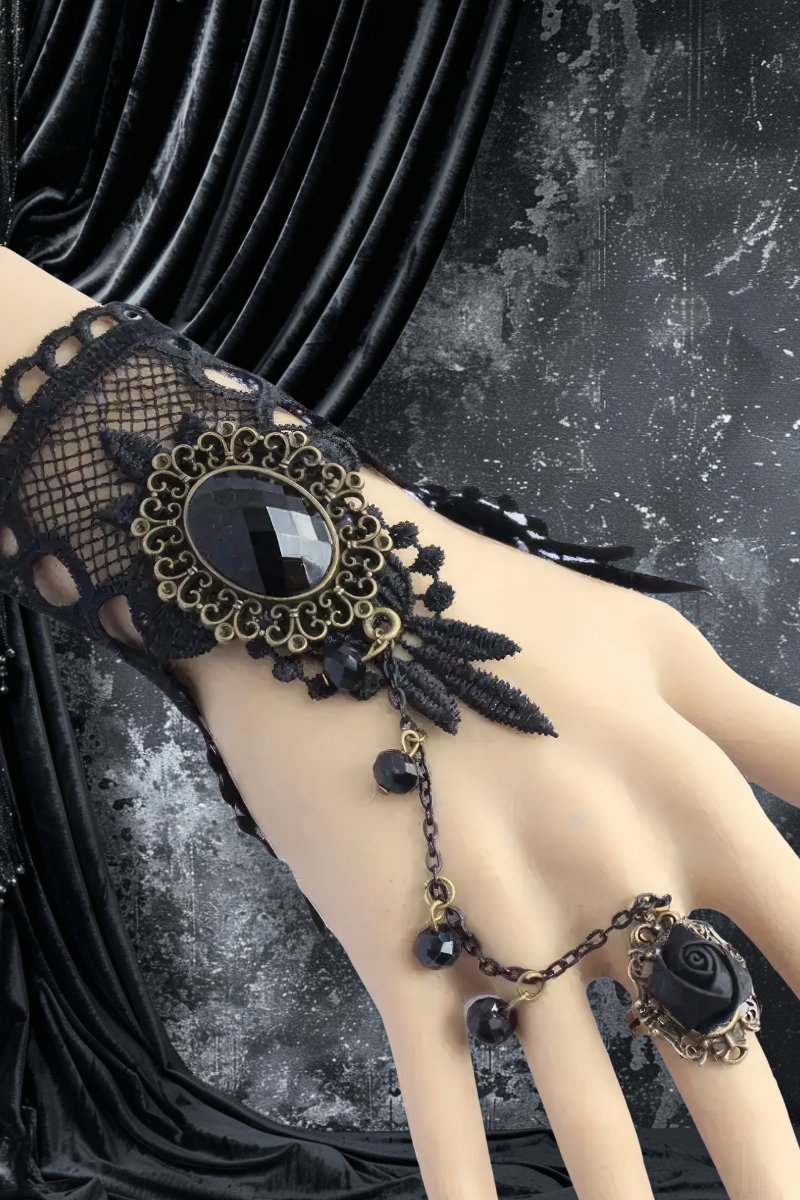 Bracelet bague gothique noire en dentelle avec pierre noire facettée et chaîne ornée de perles sur main